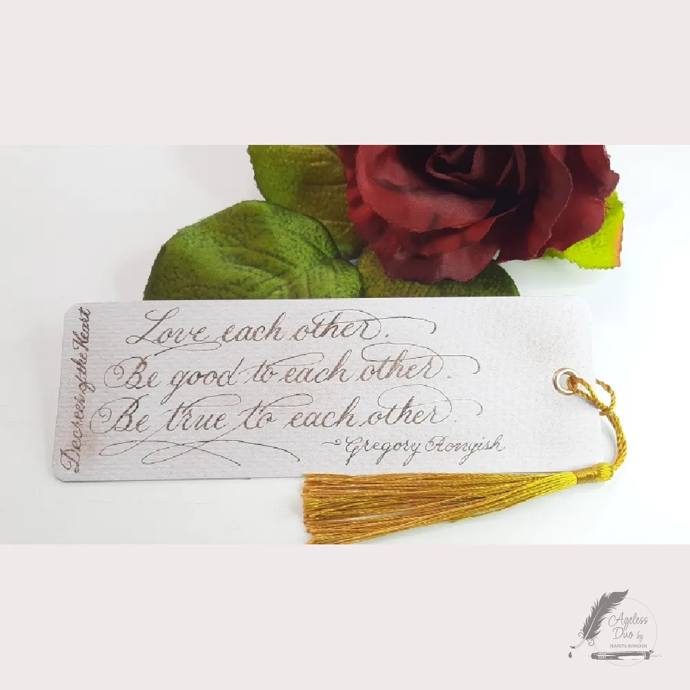 Handmade calligraphy bookmark with eyelet and tassel, written in gold metallic ink with a dip pen, featuring an original poem by Gregory Rongish