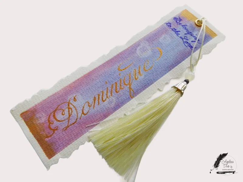 Dominique — Hand-Calligraphied Watercolor Bookmark Hand-painted watercolor bookmark with Dominique written in metallic gold calligraphy