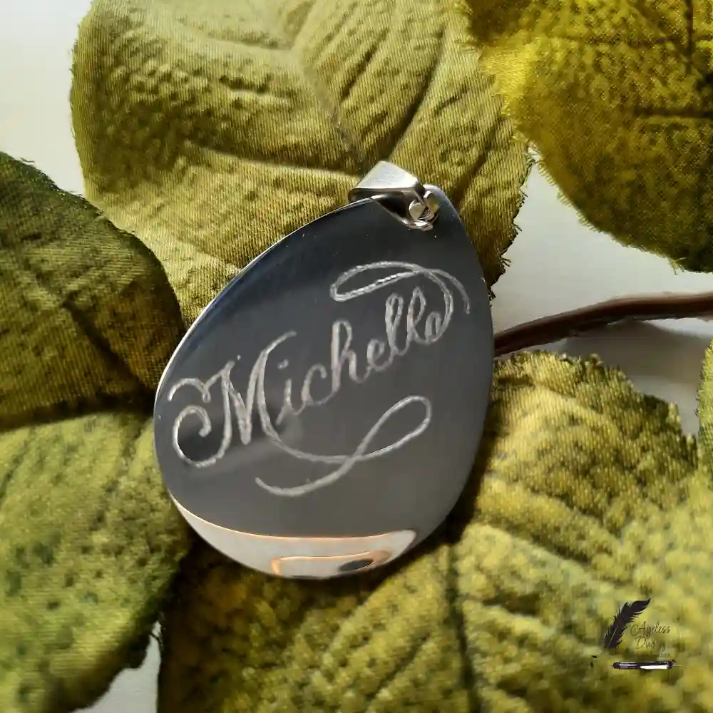 Large stainless steel teardrop pendant personalized with the name Michelle through hand engraving