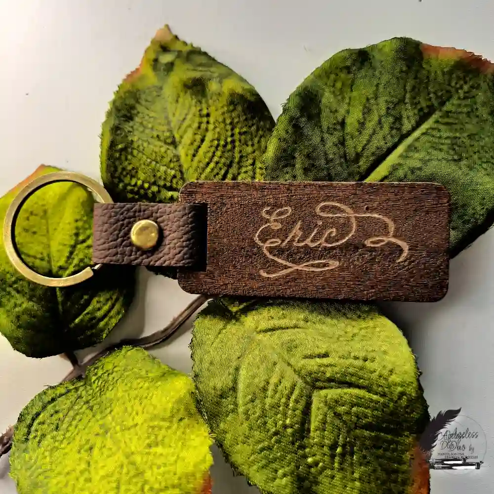 Dark wood keychain personalized with the name Eric through hand engraving