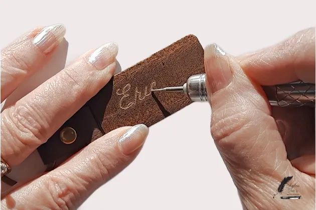 Jeanita Rongish using a rotary engraver on a wood keychain Jeanita Rongish hand engraving a personalized keepsake
